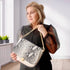 women holding white leather bag with interchangeable front flap