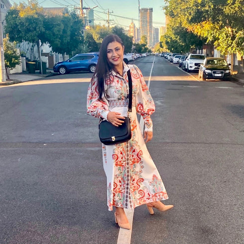 women carrying black leather bag with interchangeable front flap